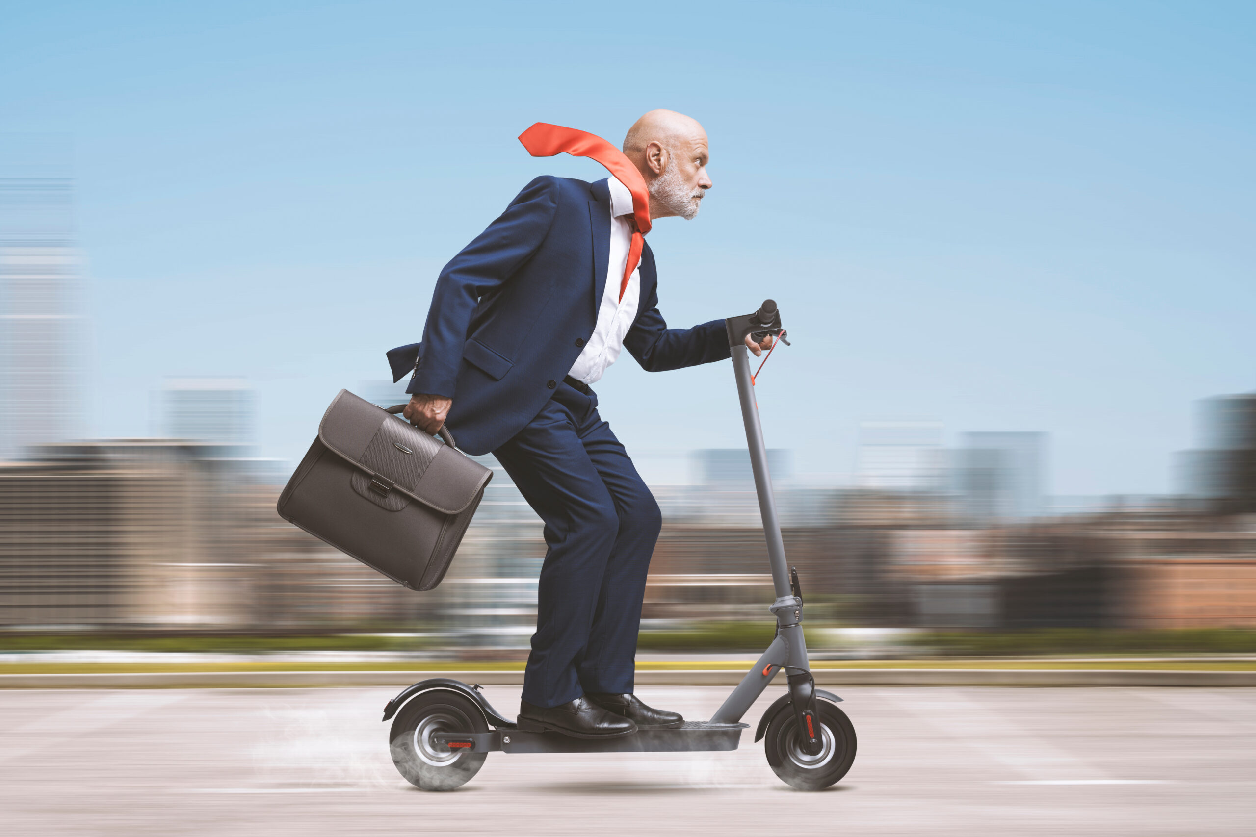 Corporate Businessman Riding A Scooter